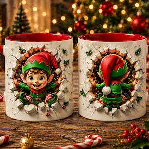 May include: Two white ceramic mugs with red interiors and handles, featuring a 3D-effect illustration of a Christmas elf. The left mug shows the elf facing forward, while the right mug shows the elf from behind, both appearing to break through a wall.