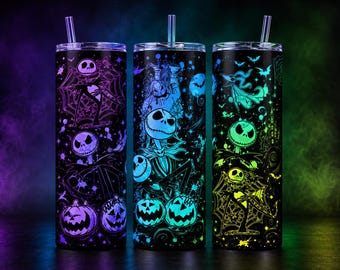 May include: Three cylindrical tumblers with lids and clear straws, featuring a black background with neon-colored illustrations of Jack Skellington, Oogie Boogie, and Zero from The Nightmare Before Christmas, including spiderwebs and jack-o'-lanterns.
