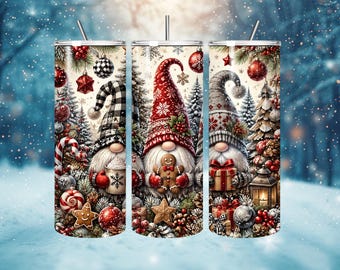 May include: Three cylindrical tumblers with straws featuring a Christmas theme. The design displays gnomes in patterned hats, gingerbread cookies, candy canes, pine trees, ornaments, and wrapped gifts against a snowy, festive winter background.