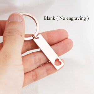 May include: Rose gold keychain with a heart cut-out on a rectangular tag. The tag is blank, with no engraving.  Blank (No engraving)