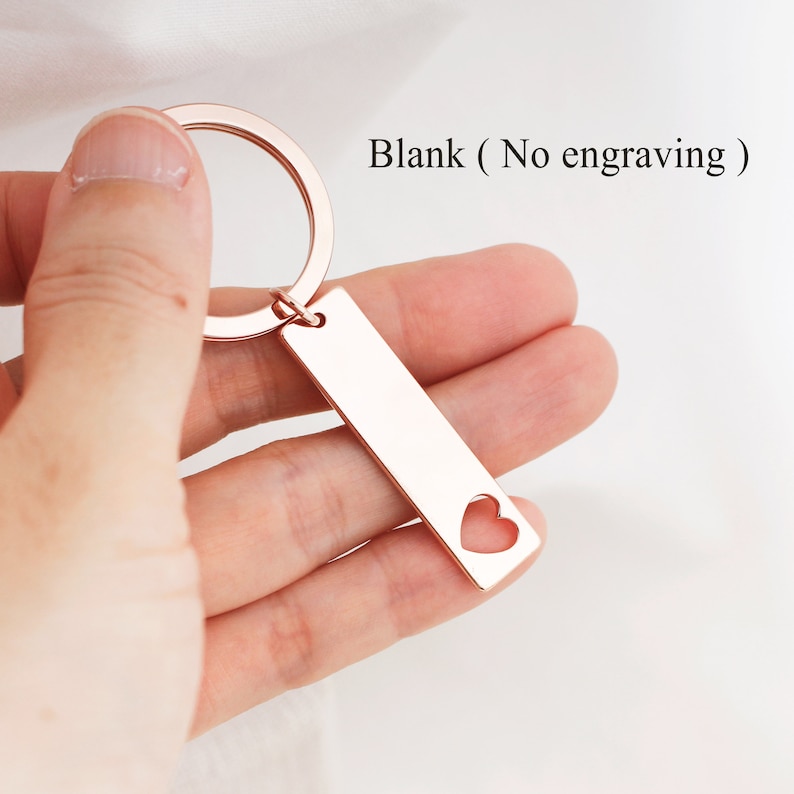 May include: Rose gold keychain with a heart cut-out on a rectangular tag. The tag is blank, with no engraving.  Blank (No engraving)
