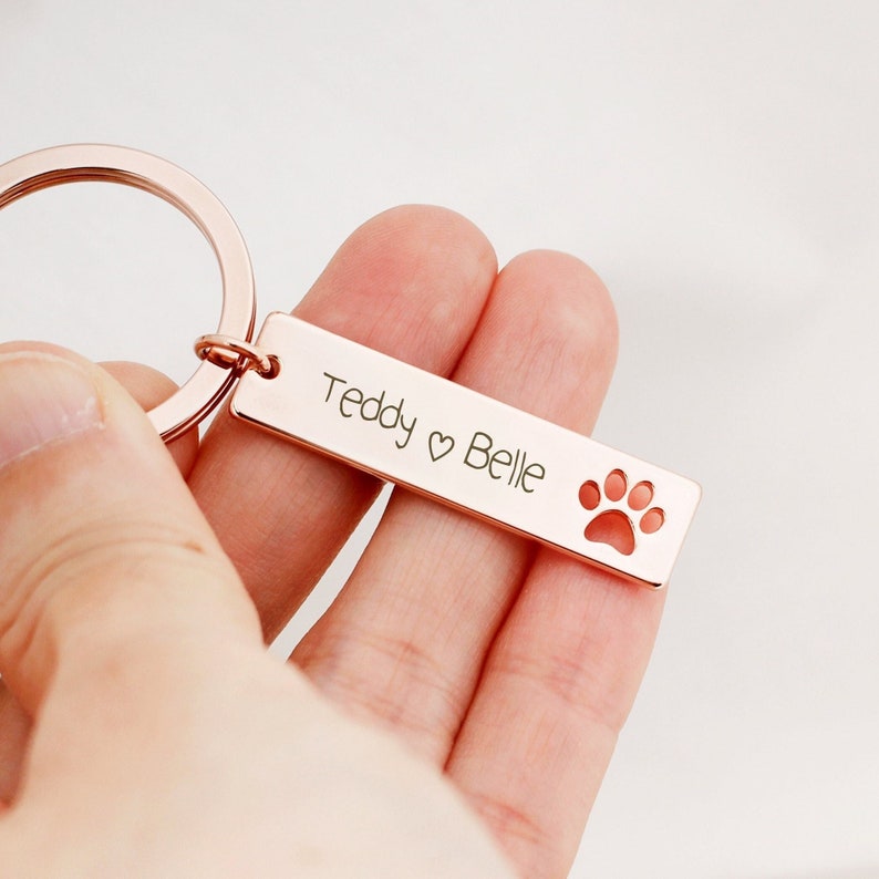 Rectangle bar keychain engraved with personalized message on it. Customers can personalize by adding birthstones and engraving such as name and birthday of their lovely dog. The most common comments about this keyring are great quality and cute!