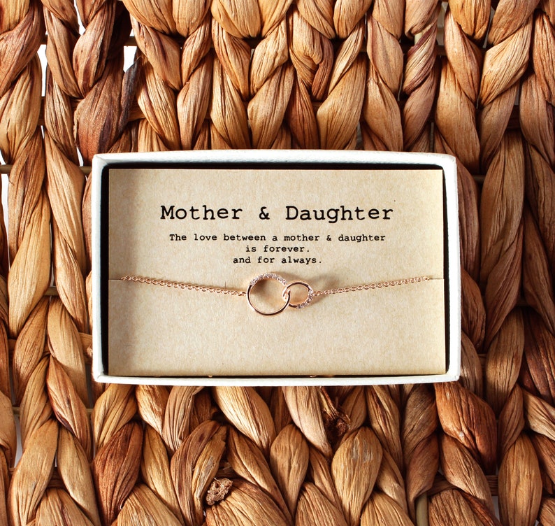Rose gold chain necklace with a pendant that linked two circles into one, wrapped in a gift box with message card. Customers can personalize it by adding birthstones of their choice. The most common comments about this necklace are dainty and cute!