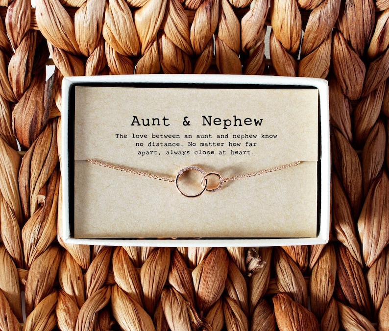 Rose gold chain necklace with interlocking circle pendant, wrapped in a gift box with message card. Customers can personalize it by adding birthstones of their choice for a loved one. The most common comments about this necklace are dainty and cute!