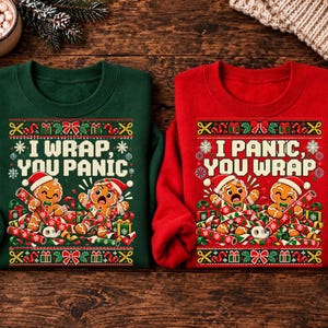 May include: A dark green sweatshirt with the text I WRAP, YOU PANIC and a red sweatshirt with the text I PANIC, YOU WRAP. Both feature gingerbread characters, gift boxes, and wrapping paper graphics with festive borders and snowflakes.