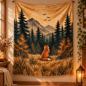 May include: A rectangular wall tapestry featuring a landscape illustration of a fox sitting in a golden field, facing a dense forest of dark green pine trees and tall, jagged mountains under a warm, amber-toned sky with four birds.