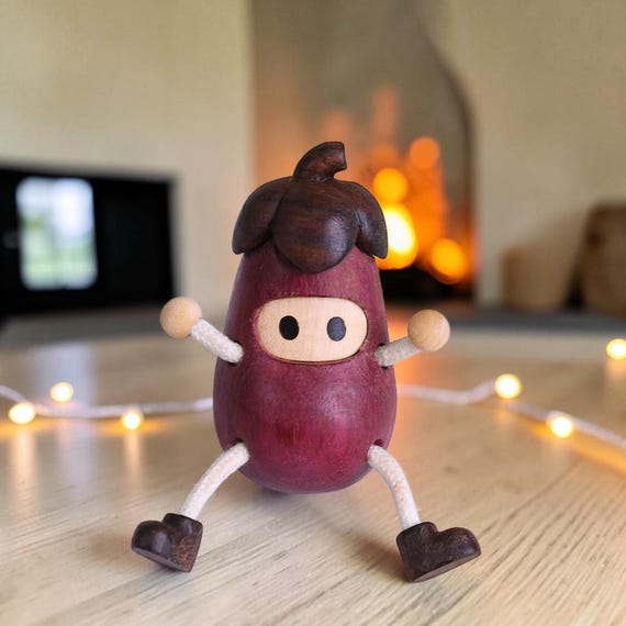 A tiny hand-carved beech wood acorn doll with kawaii charm — the kind of whimsical shelf creature that feels like it wandered out of a forest fairy tale.