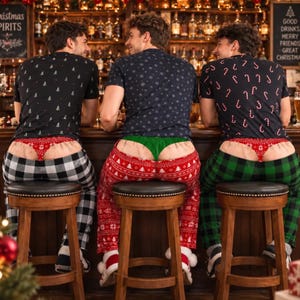 May include: Three individuals wearing short-sleeved t-shirts with holiday patterns and pajama pants in plaid and snowflake designs. Each person wears a thong-style undergarment featuring festive red or green colors and holiday-themed prints.