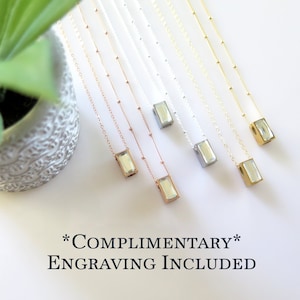 Six necklaces of a tiny rectangular crystal front urn pendant. Stainless steel  pendants hang on sterling silver, gold fill and rose gold fill chains. The chains are either plain cable or satellite with small stations. Beveled clear crystal on front.