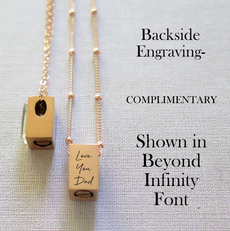 A tiny rectangle urn or ashes pendant has a crystal front and back side engraved. Wording is customized. Shown on 2 different chain options. One is a rose gold cable chain and the other is a satellite chain with tiny balls every half inch apart.
