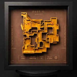 May include: A framed 3D relief map of the Dust II game level from Counter-Strike 2, featuring a yellow layout on a brown background. The display includes text details like "Released 2001," "Game Mode Competitive," "Players 10," and "Map Size 2110 m²."