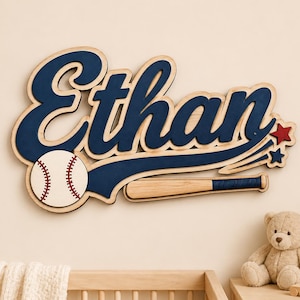 以下が含まれることがあります： 濃い青色の筆記体で「Ethan」と書かれた木製の壁掛けサイン。白い野球ボール（赤い縫い目付き）、ナチュラルウッドカラーのバット、そして赤と青の小さな星が2つデザインされており、立体感のある層状の構造になっています。