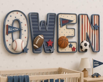May include: A wall-mounted decorative name sign spelling OWEN in large, navy blue outlined letters. Each letter features sports-themed patterns, including stars, stripes, and pennants labelled ALL STAR and MVP, with attached baseball, football, basketball, and soccer ball accents.