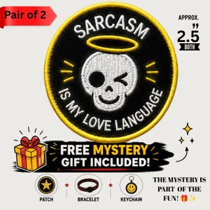 May include: A circular embroidered patch featuring a white skull with a yellow halo, winking, and the text SARCASM IS MY LOVE LANGUAGE in white letters on a black background with a yellow border, measuring approximately 2.5 inches in diameter.