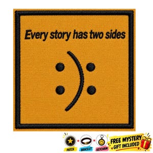 May include: A square embroidered patch with a mustard yellow background and a thick black border. The text "Every story has two sides" is stitched in black above a central graphic featuring four black dots and a curved black line.