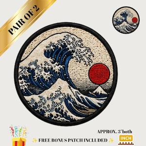 May include: A pair of circular embroidered patches featuring a depiction of a large blue ocean wave with white foam, a red sun, and a mountain peak. The patches have a black border and measure approximately 3 inches in diameter each.