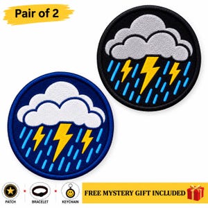 May include: A pair of circular embroidered patches featuring a white cloud, yellow lightning bolts, and blue raindrops. One patch has a black border and the other has a dark blue border. Text includes Pair of 2 and FREE MYSTERY GIFT INCLUDED.