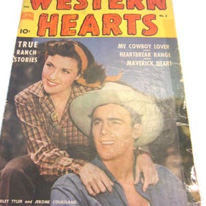 May include: A vintage Western Hearts comic book, number 2, featuring a yellow header with red text. The cover displays a color photograph of a woman in a plaid shirt and a man in a cowboy hat, with the text True Ranch Stories and My Cowboy Lover.