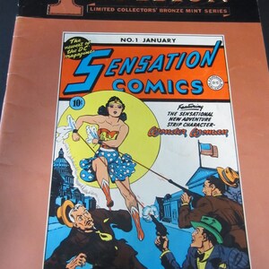 May include: A vintage comic book cover for Sensation Comics, 1st Edition, featuring Wonder Woman. The cover art shows Wonder Woman in a blue and white star-spangled skirt, with the text "Sensation Comics" in large, bold letters.