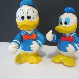 2 Disney Donald Duck Hard Plastic Banks** Vintage from 1960&#39;s **Movable Arm and Head **  You Are Buying Both Banks** Both in Great Condition