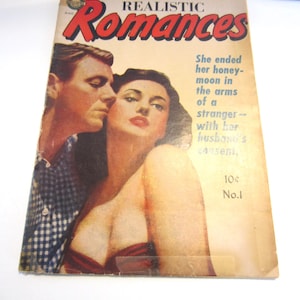 May include: A vintage comic book titled Realistic Romances No. 1, priced at 10 cents. The cover features an illustration of a man in a blue and white checkered shirt standing behind a woman with dark hair, with the text She ended her honeymoon in the arms of a stranger -- with her husband's consent.