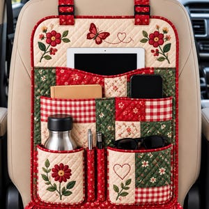 May include: A quilted car seat back organizer featuring a red, green, and cream patchwork design with floral, butterfly, and heart embroidery. It includes multiple pockets holding a tablet, notebook, smartphone, water bottle, pens, and sunglasses.