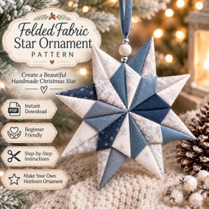 May include: A folded fabric star ornament featuring a geometric design in shades of blue, white, and grey with snowflake patterns. The star hangs from a blue ribbon with a wooden bead and includes text for a pattern download with instructions.