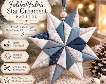 May include: A folded fabric star ornament featuring a geometric design in shades of blue, white, and grey with snowflake patterns. The star hangs from a blue ribbon with a wooden bead and includes text for a pattern download with instructions.