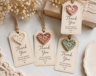 May include: Four rectangular paper gift tags with rounded corners, each featuring a crocheted heart in cream, dusty pink, or sage green. The tags are printed with the text Thank You for your support! It means the world to me. and include twine.