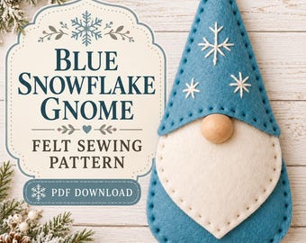 May include: A blue felt gnome ornament with a white beard, a wooden bead nose, and white embroidered snowflake details on its hat. The text reads BLUE SNOWFLAKE GNOME FELT SEWING PATTERN PDF DOWNLOAD. The gnome has visible stitching along the edges.