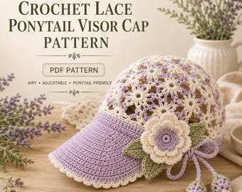 May include: A crochet lace ponytail visor cap with a lavender and cream floral pattern. The cap features a solid lavender brim, a large layered lavender and cream flower applique with green leaves, and two dangling lavender and cream flower buds.