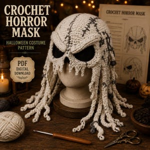 May include: A cream-colored crochet horror mask featuring dark grey stitched details, deep eye sockets, and long dangling tendrils. The mask is displayed on a mannequin head, accompanied by text reading CROCHET HORROR MASK HALLOWEEN COSTUME PATTERN PDF DIGITAL DOWNLOAD.