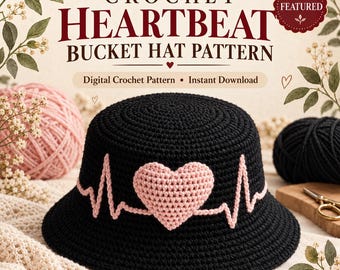 May include: A black crochet bucket hat featuring a light pink heart centered on the front, with a light pink EKG heartbeat line extending across the sides. The text reads CROCHET HEARTBEAT BUCKET HAT PATTERN, Digital Crochet Pattern, Instant Download.