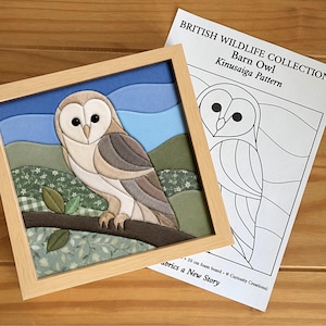 May include: A framed fabric barn owl art piece featuring a tan and white owl perched on a brown branch against a blue sky and green hills, accompanied by a printed paper pattern titled British Wildlife Collection Barn Owl Kinusaiga Pattern.