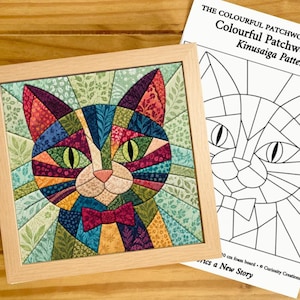 May include: A framed Kinusaiga fabric art piece featuring a colorful patchwork cat with green eyes and a bow tie, accompanied by a printed paper pattern sheet titled The Colourful Patchwork Collection Colourful Patchwork Cat Kinusaiga Pattern.