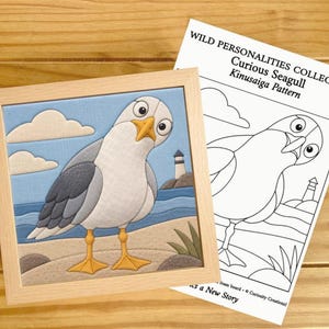 May include: A framed fabric kinusaiga art piece depicting a seagull on a beach with a lighthouse, accompanied by a printed paper pattern titled WILD PERSONALITIES COLLECTION Curious Seagull Kinusaiga Pattern with line art illustrations.