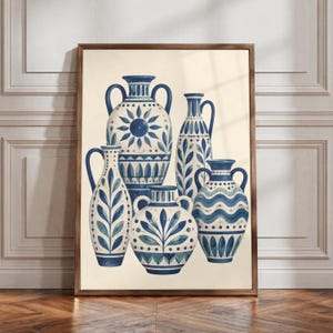 May include: A framed wall art print featuring five ceramic vases in varying shapes and sizes. Each vessel is decorated with blue and white patterns, including floral motifs, wavy lines, and geometric shapes, set against a cream background.