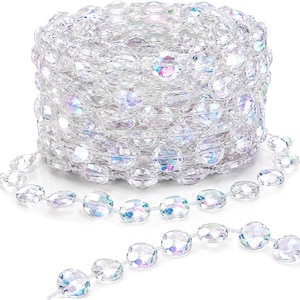 May include: A continuous spool of clear, faceted acrylic beads with an iridescent finish. The beads are round and linked together by a thin, transparent string, creating a long, reflective garland that catches light with rainbow-like hues.