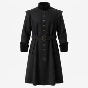 May include: A black knee-length coat featuring a high collar, long sleeves with wide cuffs, and structured shoulders. The coat has a central row of metallic buttons, a matching fabric belt with a rectangular buckle at the waist, and two pockets.