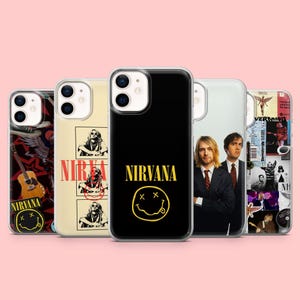 May include: Five clear phone cases featuring various Nirvana-themed designs. One case shows a black background with a yellow Nirvana logo and smiley face. Others display band photography, collage-style graphics, and acoustic guitar imagery.