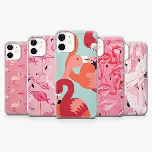 May include: A collection of five clear smartphone cases featuring various flamingo patterns. The designs include pink, coral, and white flamingos on light pink, teal, and white backgrounds, each with a dual-lens camera cutout at the top left.