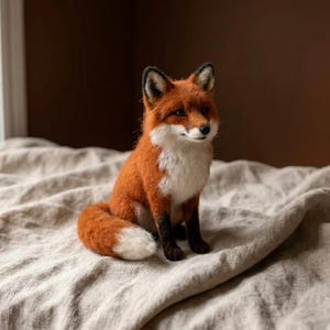 May include: A needle-felted fox figurine featuring a vibrant orange coat, a white chest and muzzle, black-tipped ears, and dark brown legs. The fox has a bushy tail with a white tip and is depicted in a seated position with a realistic expression.