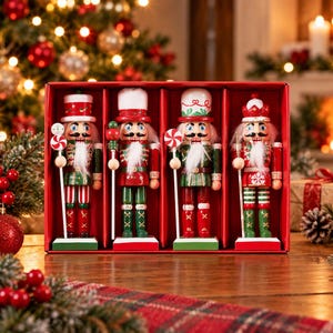 May include: A set of four wooden nutcracker figurines displayed in a red box. Each nutcracker wears a festive uniform in shades of red, green, and white, featuring painted details, white faux fur beards, and holding small candy-themed accessories.