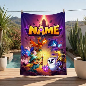 May include: A rectangular towel featuring a vibrant fantasy illustration with the text NAME at the top. The design includes a central wizard character holding a glowing staff, surrounded by various colorful creatures, floating rocks, and a bright light source.