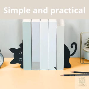 May include: A set of black metal cat-shaped bookends holding five books upright. The left piece features a cat head with white eyes, and the right piece shows a cat tail. The text "Simple and practical" is displayed at the top of the image.