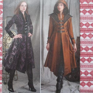 May include: Two women's coats, one black with a floral pattern and the other brown with a hood. Both coats have a long, flowing style and are cinched at the waist.