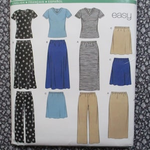 May include: A sewing pattern envelope featuring illustrations of various clothing items including V-neck tops, long skirts, short skirts, and trousers in black floral, solid blue, striped, and tan colors with the word easy printed at the top.