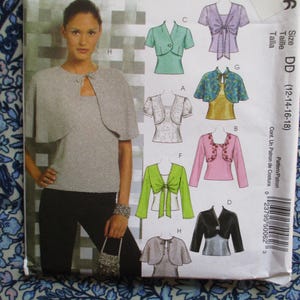 May include: A sewing pattern showing a woman in a grey top and bolero. The pattern includes illustrations of different bolero styles in colours such as green, pink, and black. The size range is DD (12-14-16-18).
