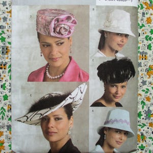 May include: Image of a pattern sheet featuring various women's hats. The hats include a pink embellished pillbox hat with a large flower, a white cloche hat, a black feathered hat, a light blue hat with a zig-zag trim, and a black and white patterned hat.
