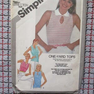 May include: Vintage sewing pattern for one-yard tops. The pattern features illustrations of various top styles, including a striped top with a keyhole detail and a white collar. The pattern includes instructions for three sizes.